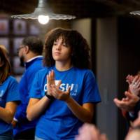 Two Thompson Scholar students clapping